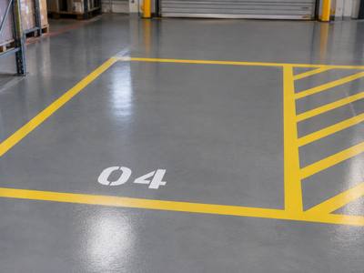 Numbered bay marking and hatched border on a coated floor