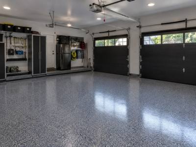 Grey flake epoxy floor across a two car garage