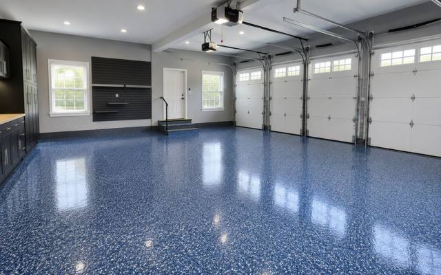 Blue flake epoxy floor running the width of a three bay garage