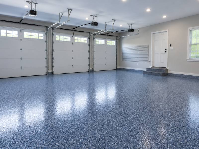 Blue flake floor running the full width of a three bay garage